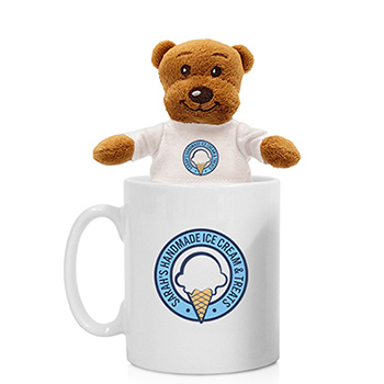Teddy bear stuffed animal sitting in a coffee mug.