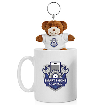 Teddy bear key chain sitting in a coffee mug.